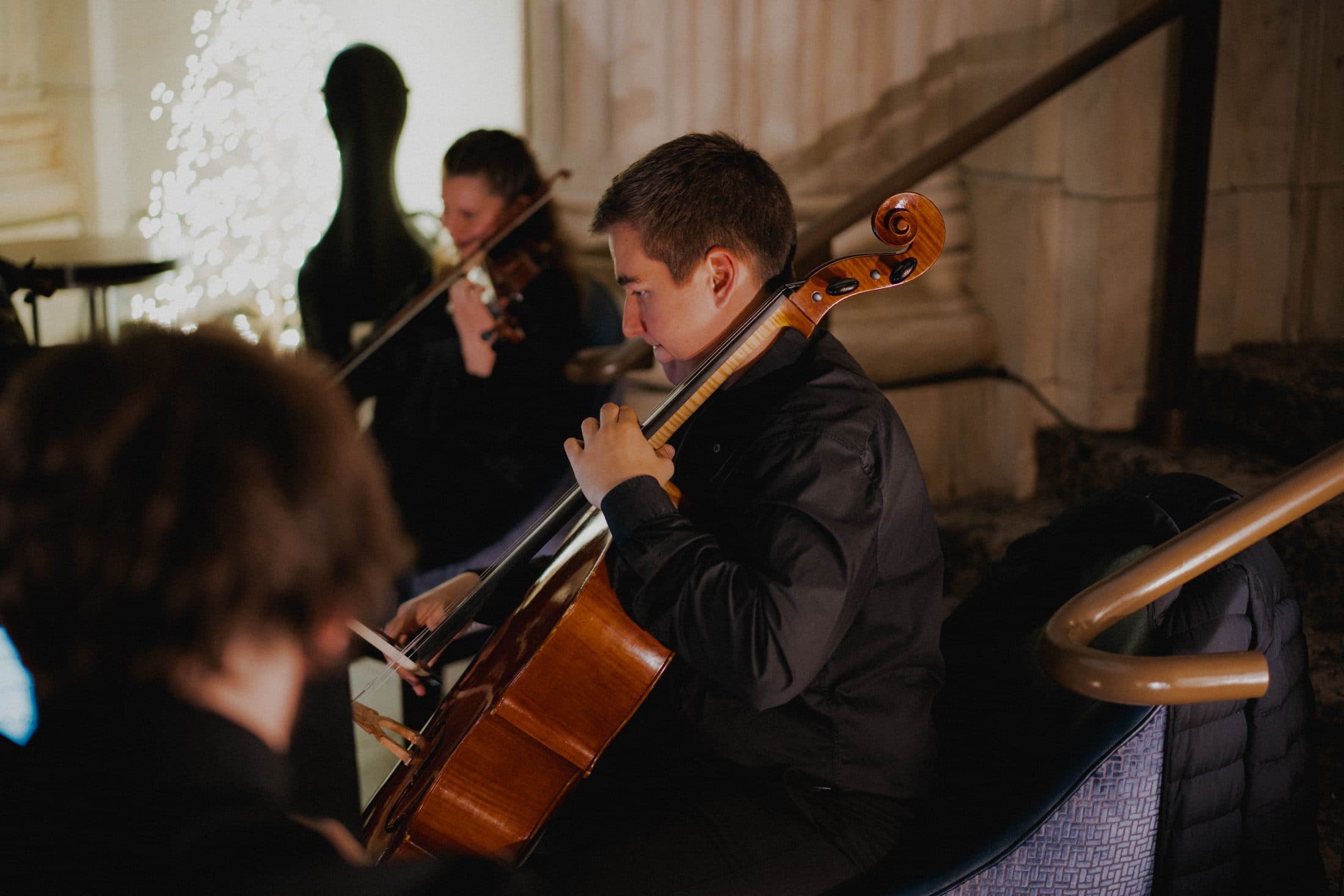 Cellist performing in a marble hall