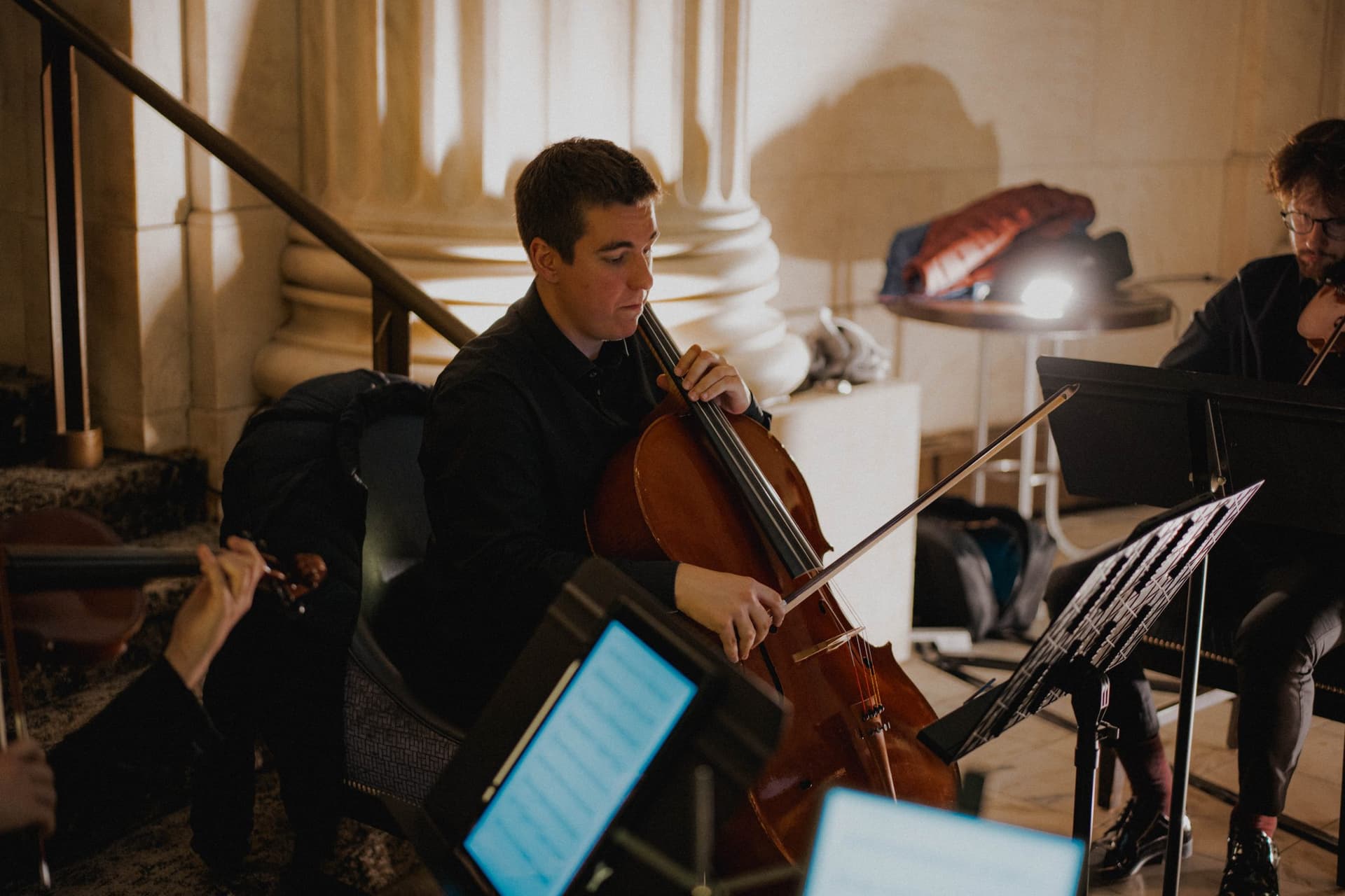 Cellist reading from a tablet during a performance
