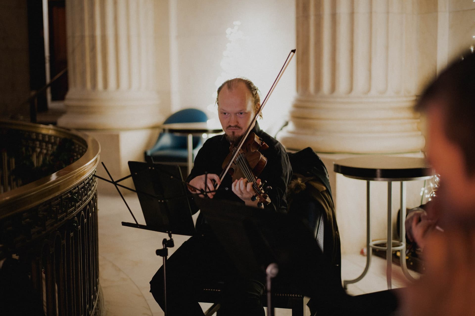 Violinist performing in a marble hall