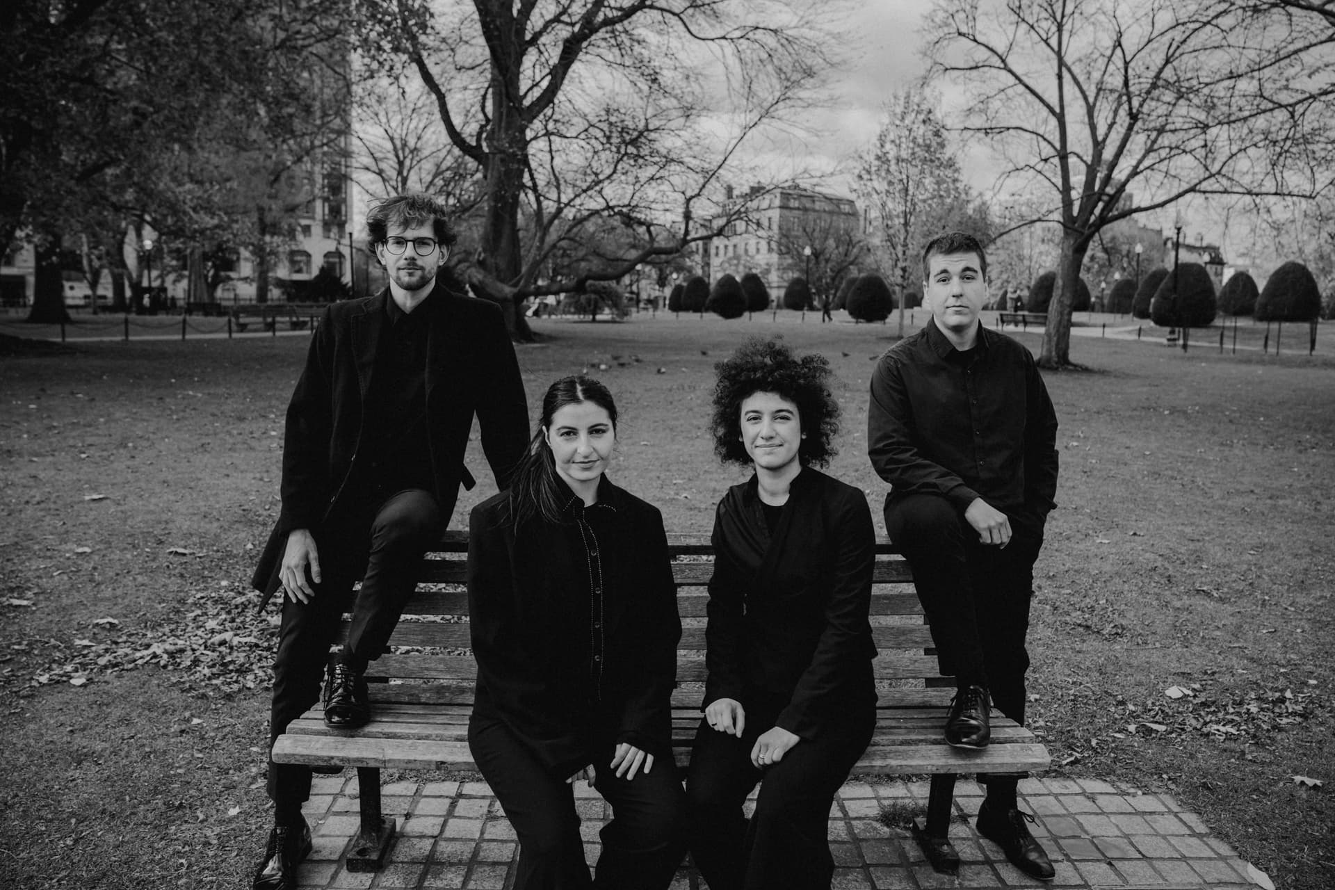 The quartet on a park bench, in black and white