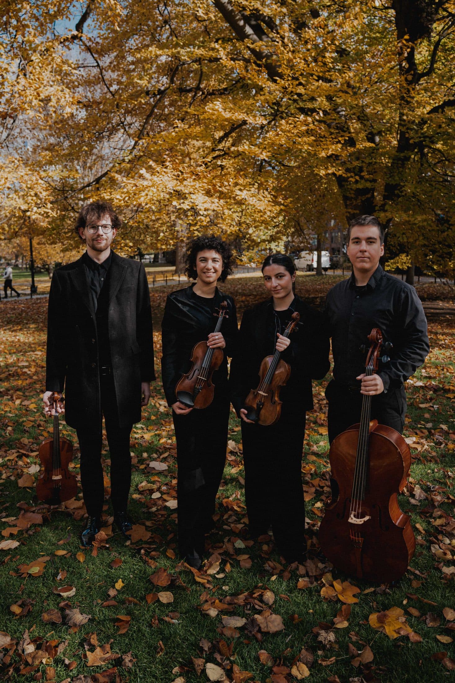 The quartet standing with their instruments