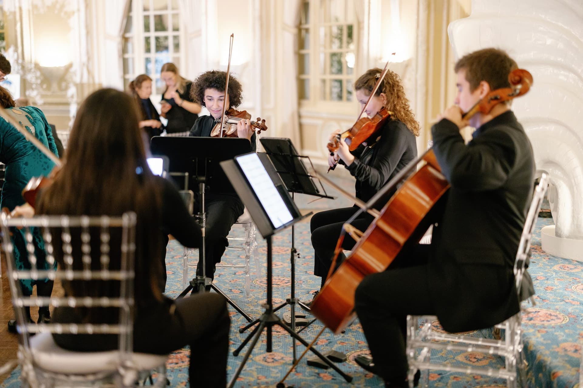 The quartet performing in an elegant ballroom