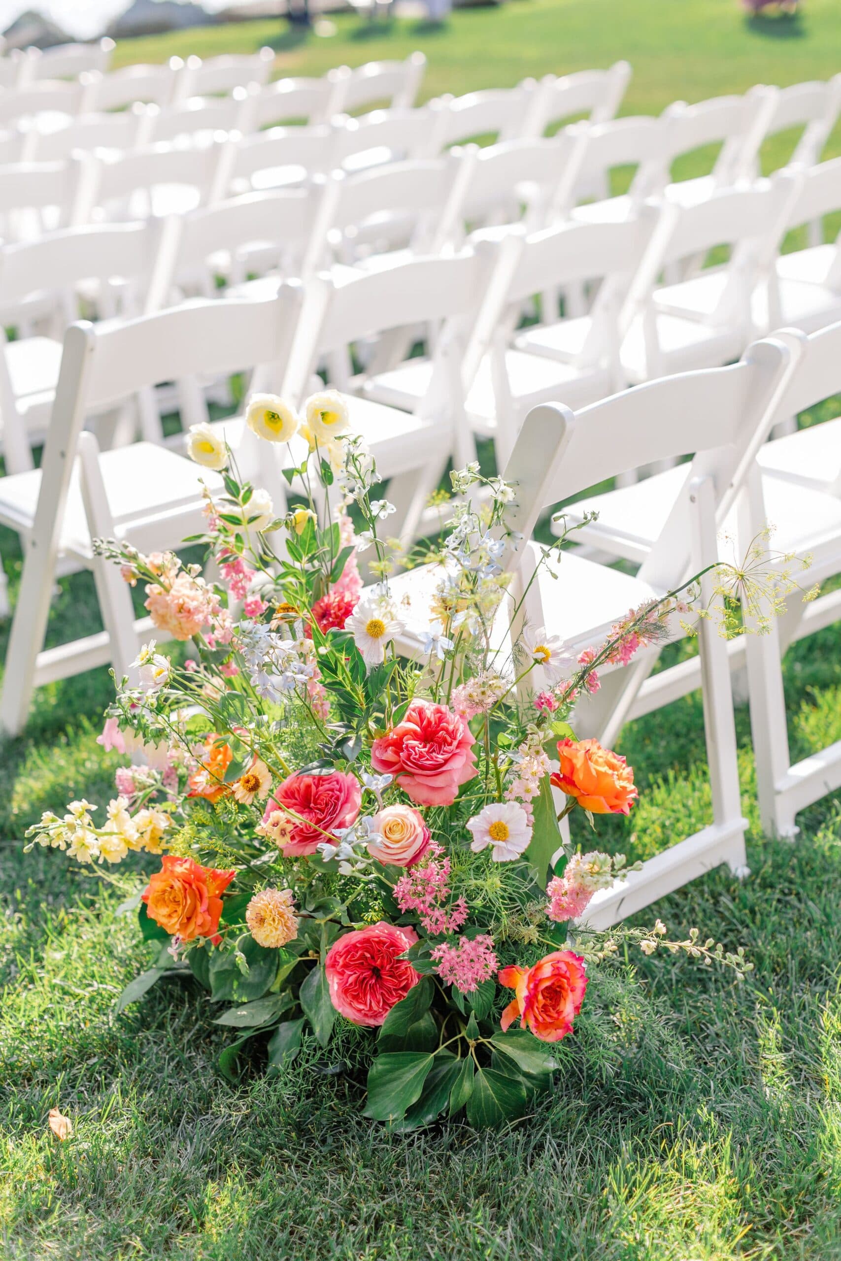 Wildflower bouquet beside the ceremony chairs
